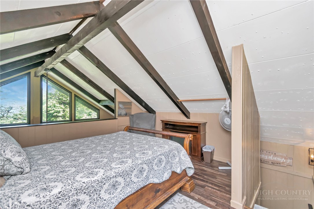 115 North Pinnacle Ridge Road, Unit 46 Beech Mountain, NC 28604 - Photo 33 of 42 a bedroom with a bed next to a window