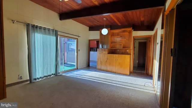 a view of a hallway with wooden floor and door