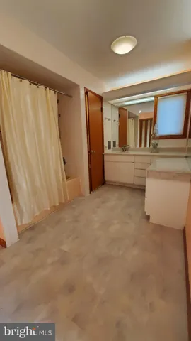 a view of an empty room with wooden shelves