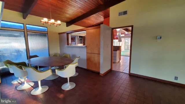 a living room with furniture a large window and wooden floor