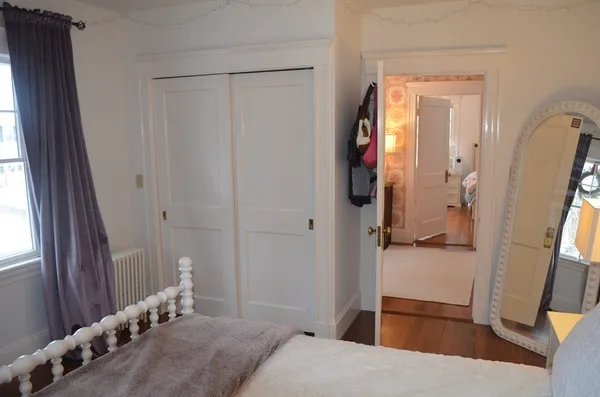 a bedroom with a bed and a large mirror in it