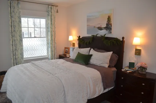 a bed sitting in a bedroom next to a window