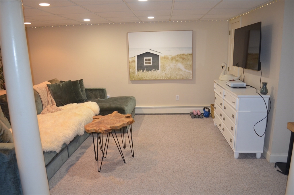 10 Berwick Road Lexington, MA 02420 - Photo 17 of 19 a living room with furniture and a flat screen tv