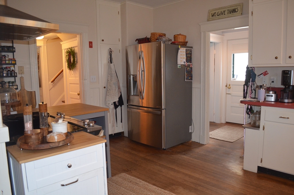 10 Berwick Road Lexington, MA 02420 - Photo 4 of 19 a kitchen with stainless steel appliances granite countertop a refrigerator and a stove