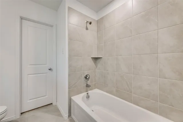 a bathroom with a granite countertop sink a toilet and a mirror
