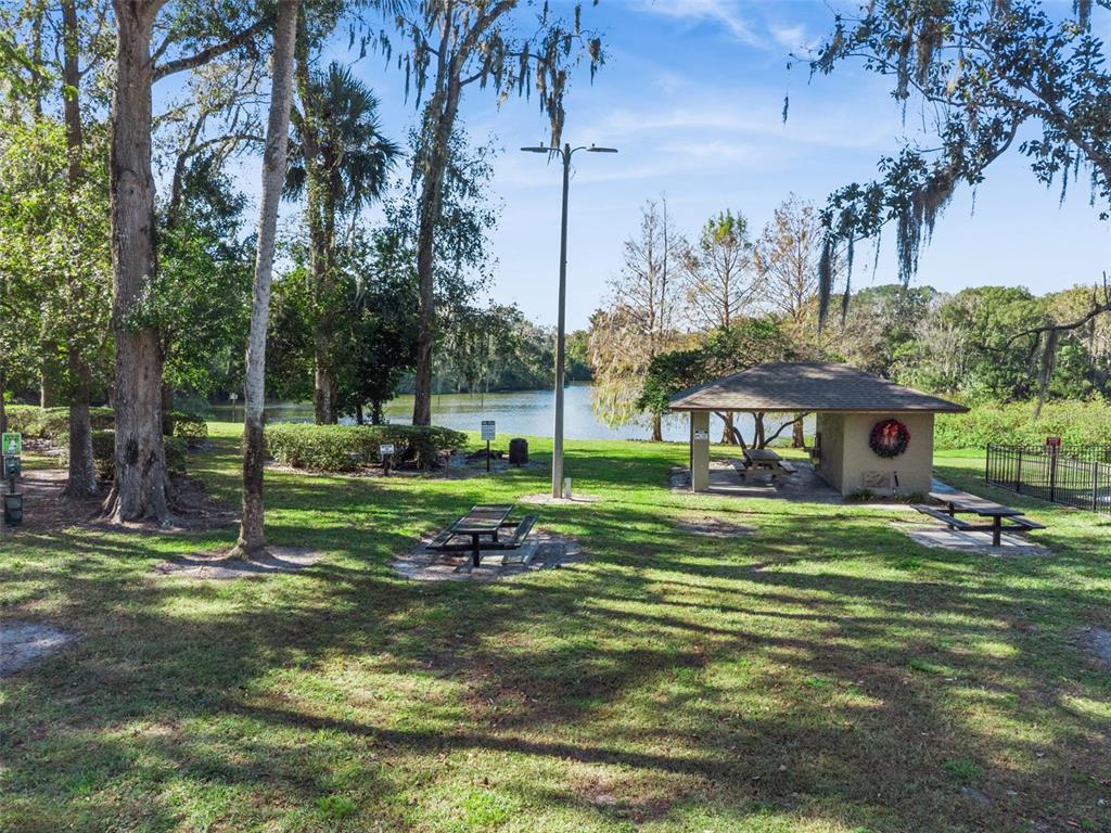 40 Moree Loop, Unit 7 Winter Springs, FL 32708 - Photo 23 of 31 a view of a house with a big yard and palm trees