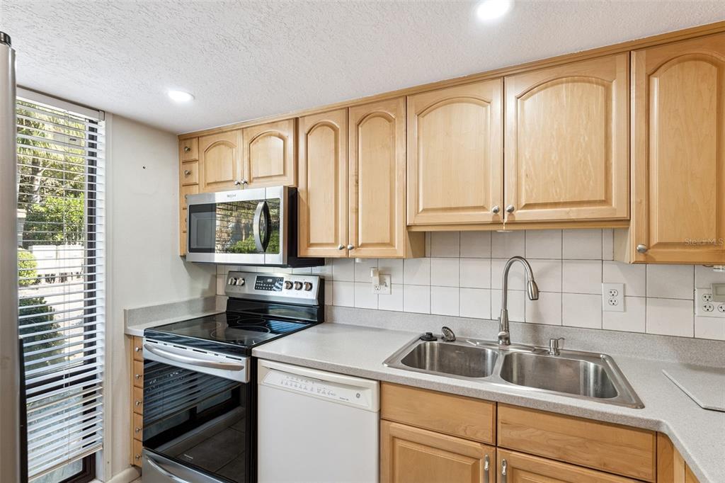 40 Moree Loop, Unit 7 Winter Springs, FL 32708 - Photo 8 of 31 a kitchen with stainless steel appliances granite countertop a sink a stove and cabinets