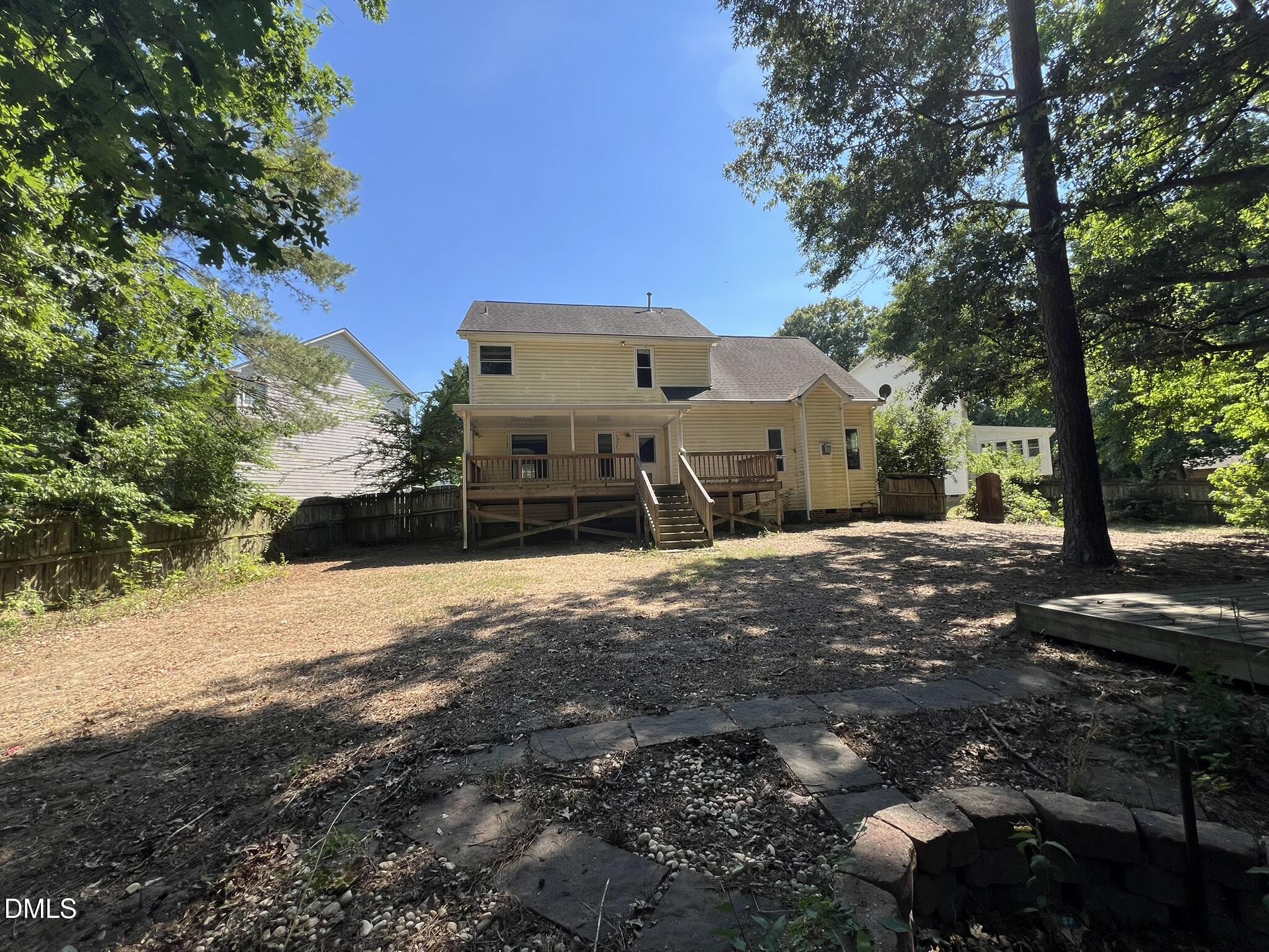 1016 Flower Round Court Raleigh, NC 27610 - Photo 22 of 23 Rear exterior featuring a two-story residence with a multi-level wood deck and stairs