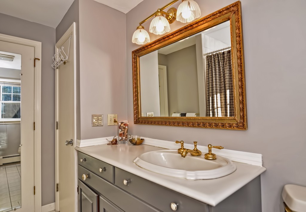 13 Phyllis Road Foxboro, MA 02035 - Photo 11 of 30 a bathroom with a sink and a mirror