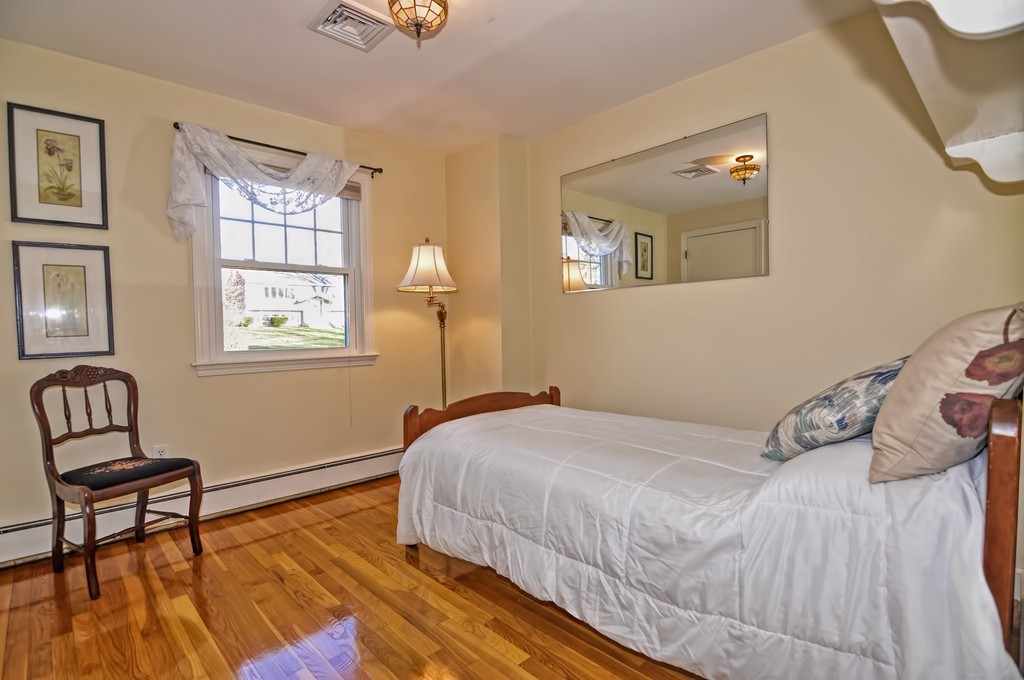 13 Phyllis Road Foxboro, MA 02035 - Photo 13 of 30 a bedroom with a bed and wooden floor