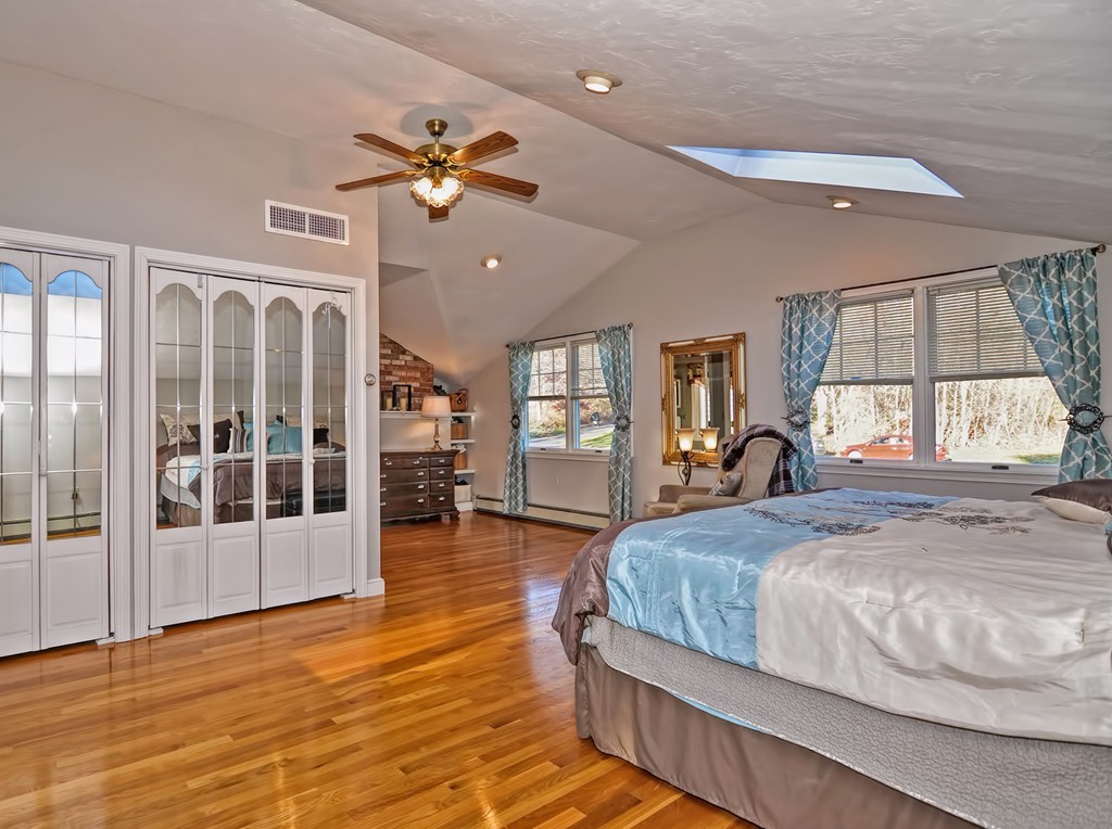 13 Phyllis Road Foxboro, MA 02035 - Photo 18 of 30 a bedroom with a large bed and a chandelier