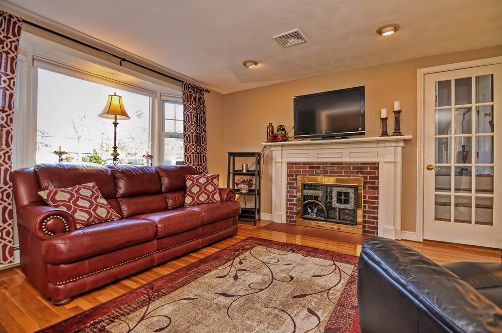 13 Phyllis Road Foxboro, MA 02035 - Photo 2 of 30 a living room with furniture flat screen tv and a fireplace