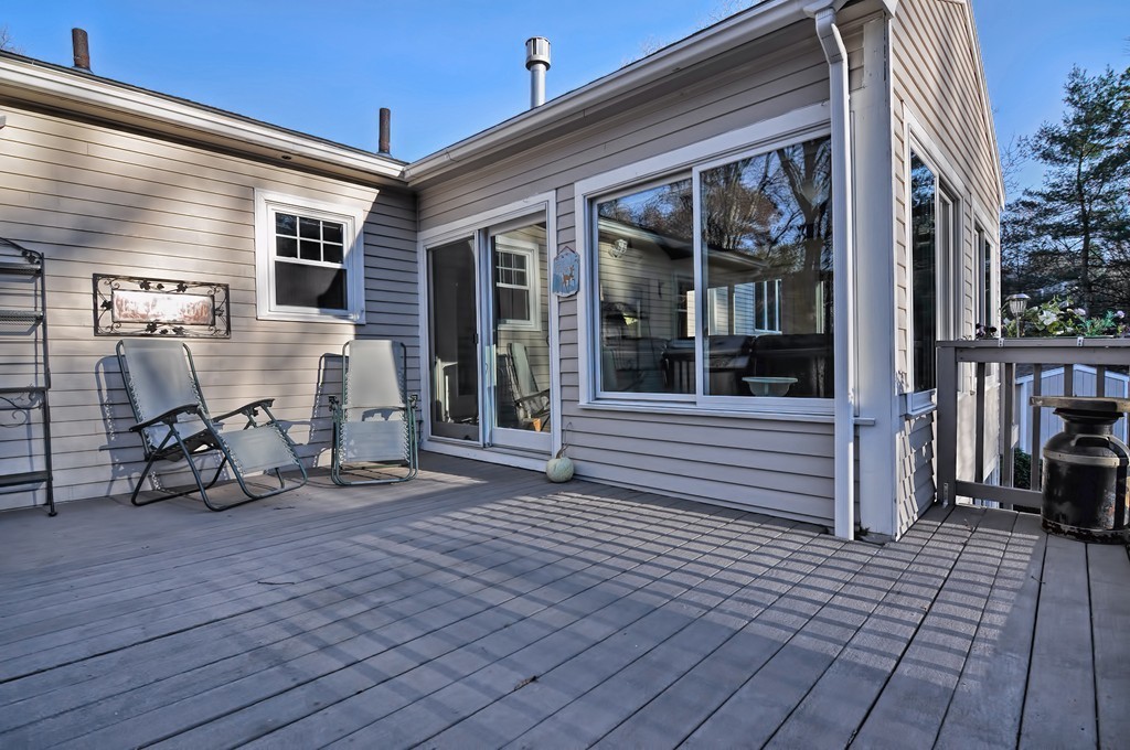 13 Phyllis Road Foxboro, MA 02035 - Photo 28 of 30 a view of a deck with table and chairs and wooden floor