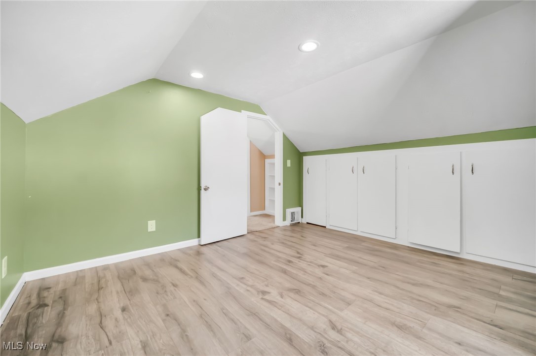 5674 Middle Ridge Road Madison, OH 44057 - Photo 23 of 26 Bedroom featuring wood-type flooring and vaulted ceiling