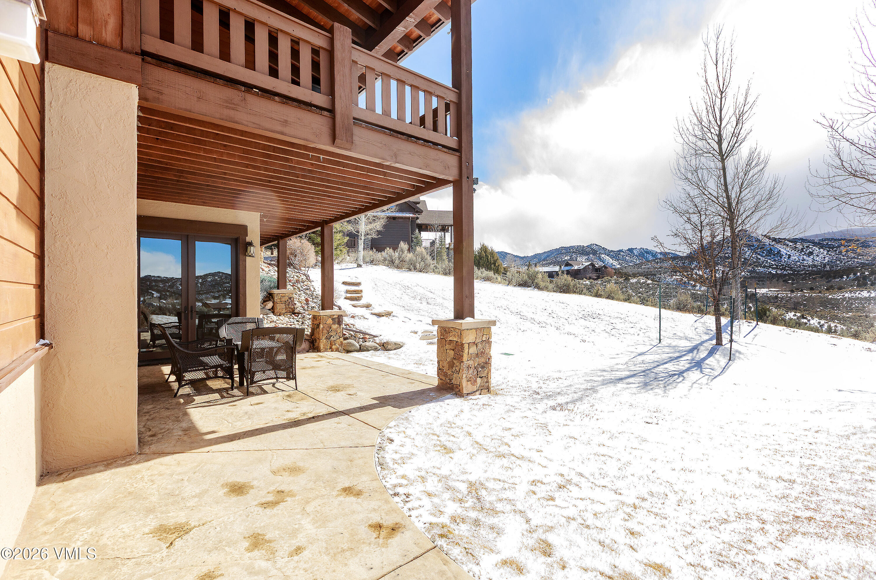 2753 East Haystacker Drive Eagle, CO 81631 - Photo 40 of 41 a view of a patio with a table and chairs and couches under an umbrella