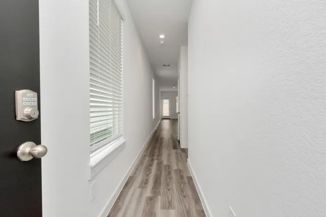 a view of a room with wooden floor and windows
