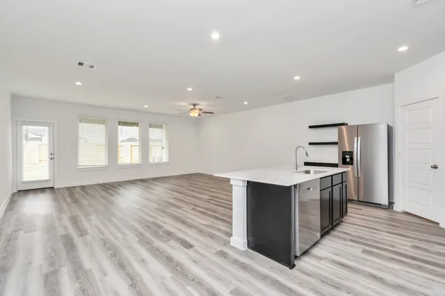 a kitchen with stainless steel appliances granite countertop a sink and stove top oven