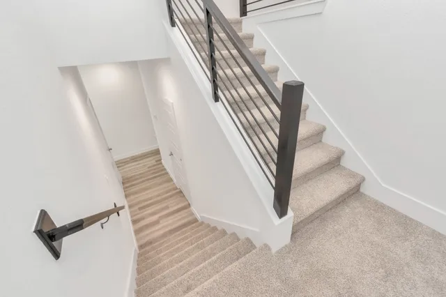 a view of a kitchen with a sink a kitchen island with wooden floor and a refrigerator