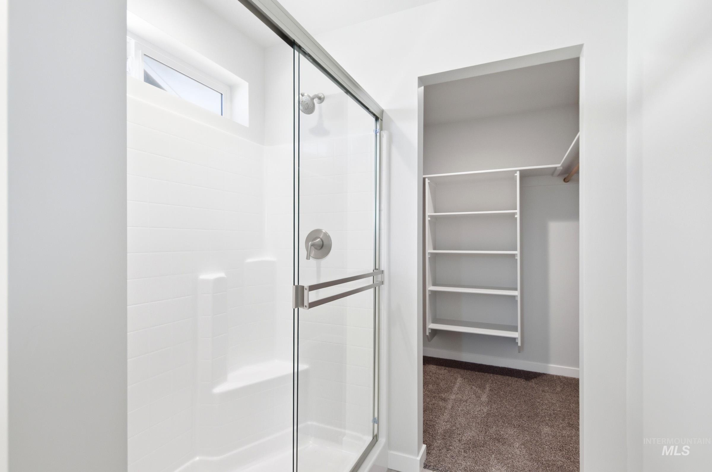 10800 Rutland Street Caldwell, ID 83605 - Photo 18 of 21 Shower enclosure featuring a sliding glass door and brushed nickel fixtures