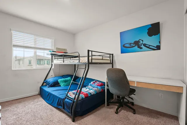 a bedroom with a bed and a chair