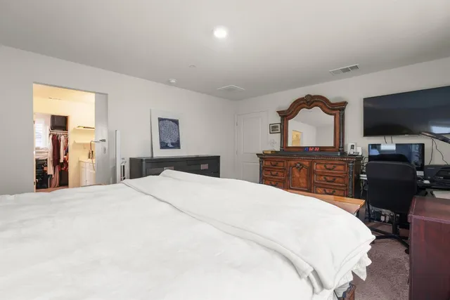 a bedroom with a bed and a television