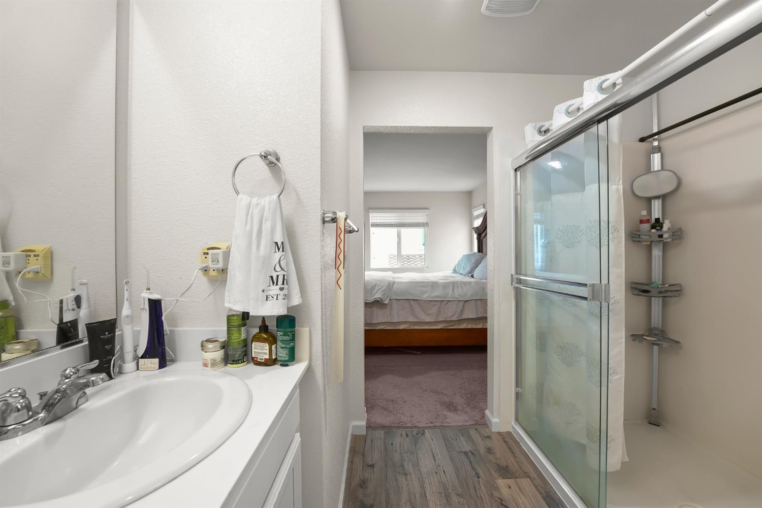 11789 Socrates Way Rancho Cordova, CA 95742 - Photo 16 of 23 a bathroom with a tub shower vanity and a sink