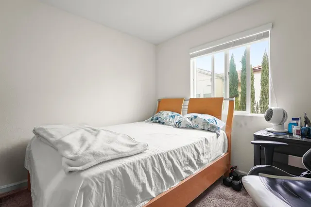 a bedroom with a bed and window