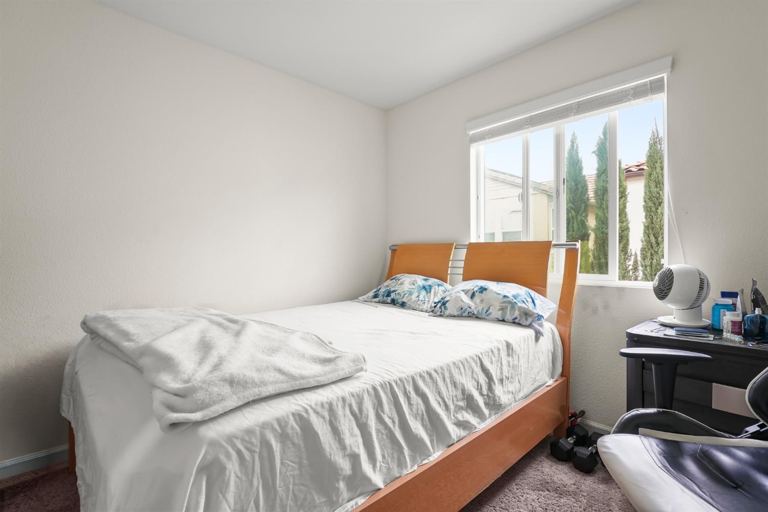 11789 Socrates Way Rancho Cordova, CA 95742 - Photo 17 of 23 a bedroom with a bed and window