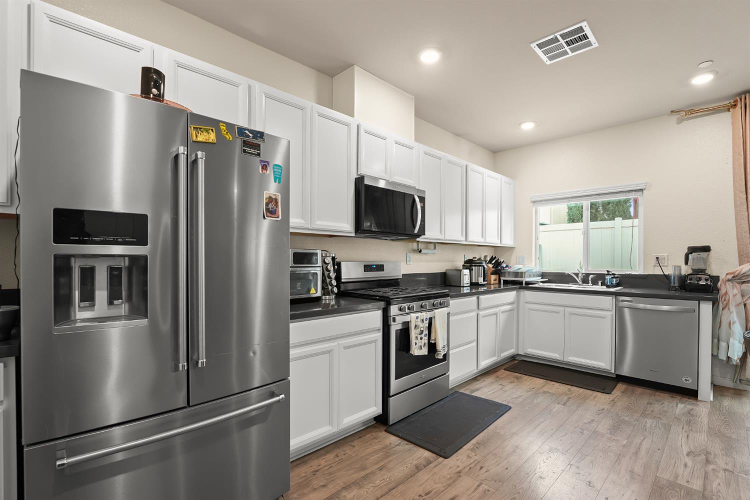 11789 Socrates Way Rancho Cordova, CA 95742 - Photo 5 of 23 a kitchen with a refrigerator and a stove top oven