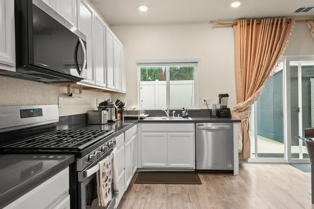 a kitchen with stainless steel appliances a sink dishwasher stove and microwave