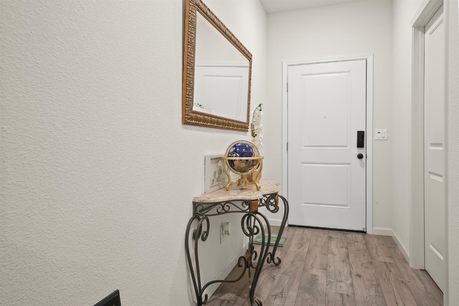 11789 Socrates Way Rancho Cordova, CA 95742 - Photo 8 of 23 a view of a hallway with wooden floor