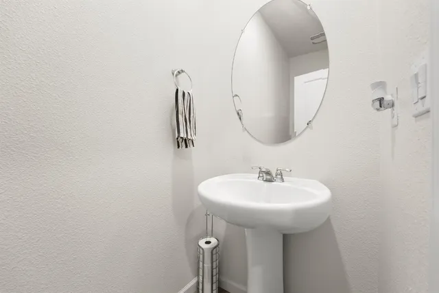 a bathroom with a sink a mirror and a toilet
