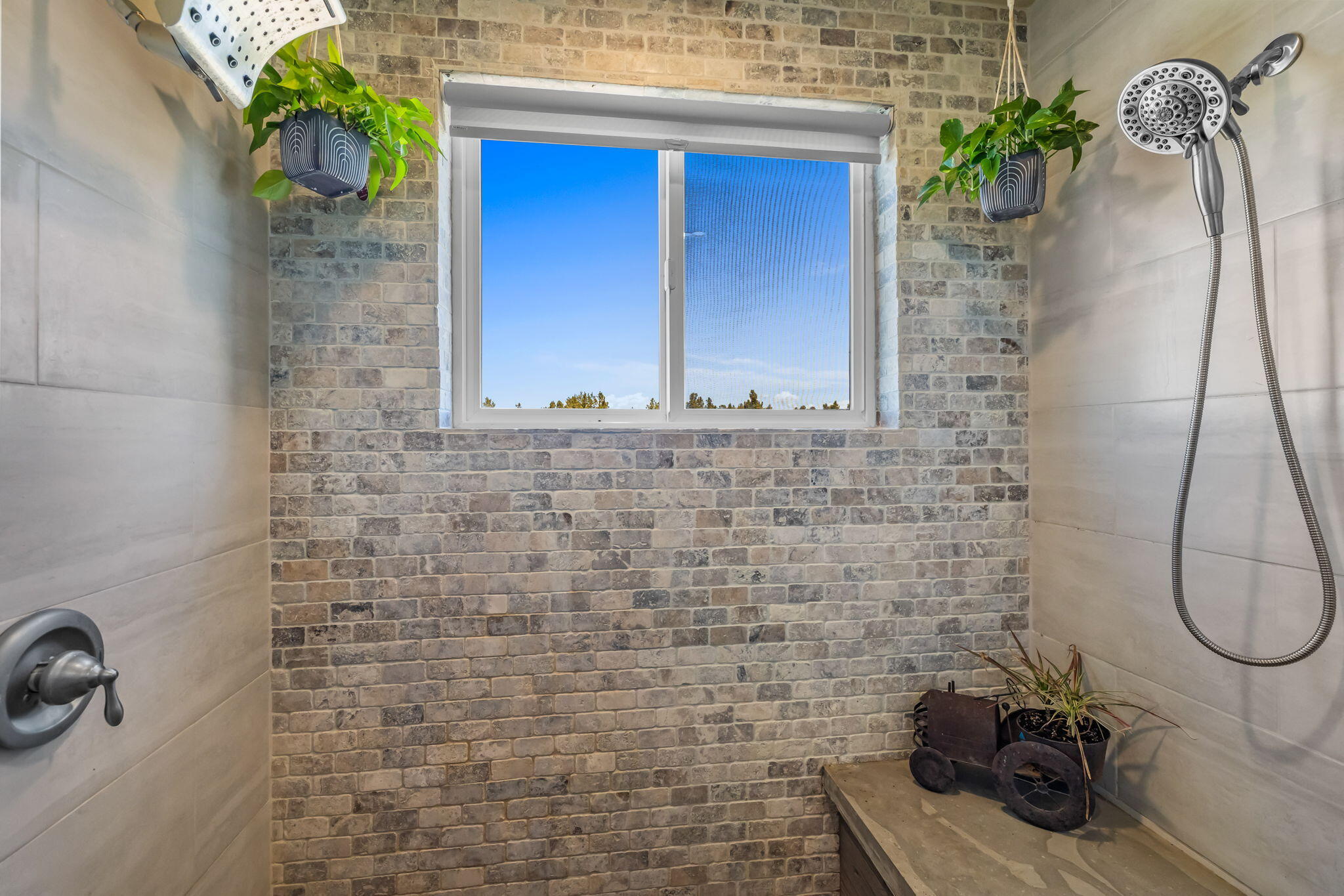 6040 Gravett Road Prineville, OR 97754 - Photo 24 of 77 a bathroom with a sink a potted plant and a mirror