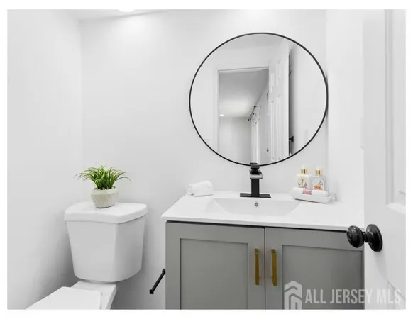 a bathroom with a sink mirror and toilet