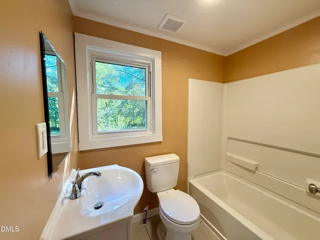 a white toilet sitting next to a bathroom sink