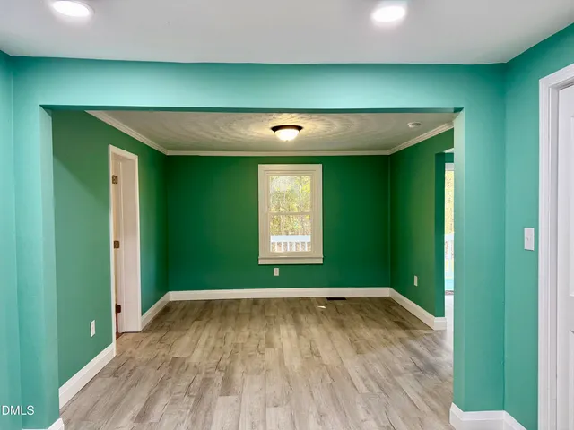 a view of a room with wooden floor and windows