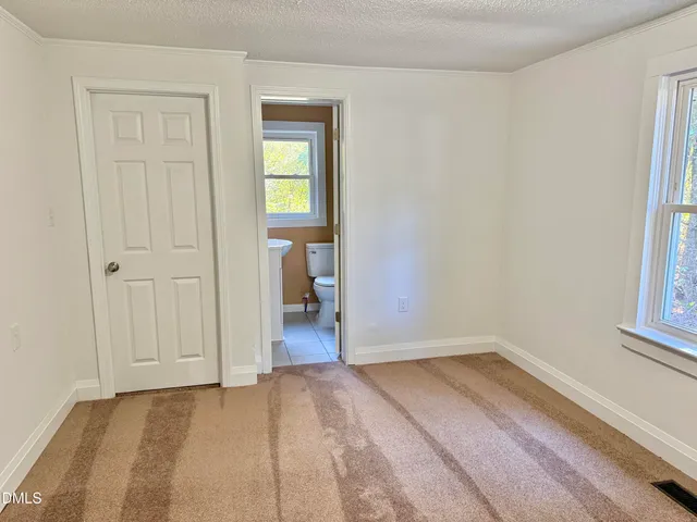 a view of a room that has a bed in it