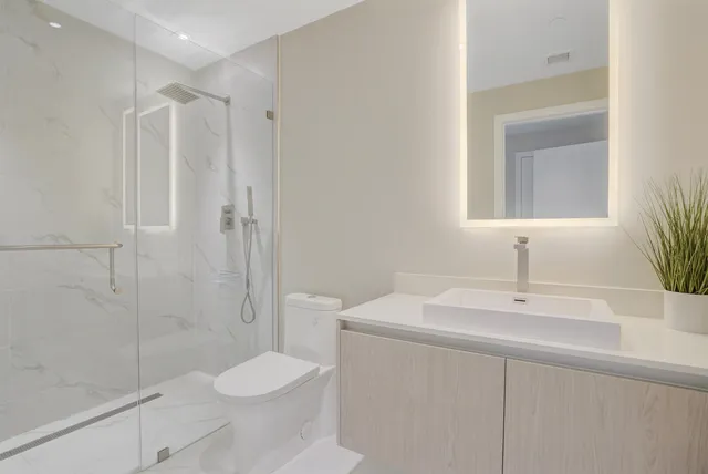 a bathroom with a sink toilet and shower