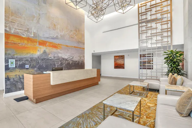 a bedroom with furniture and a large window