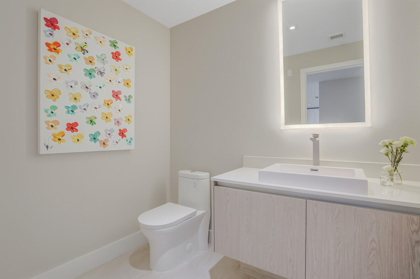 3100 North Ocean Drive, Unit 1202P Singer Island, FL 33404 - Photo 7 of 17 a bathroom with a toilet sink and mirror