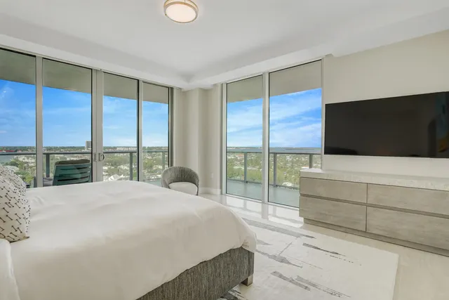 a large bedroom with a bed and large window