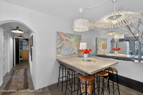 a view of a dining room with furniture and chandelier