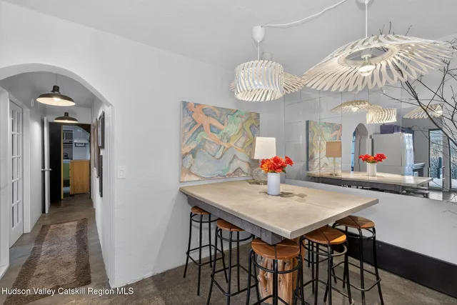 a view of a dining room with furniture and chandelier