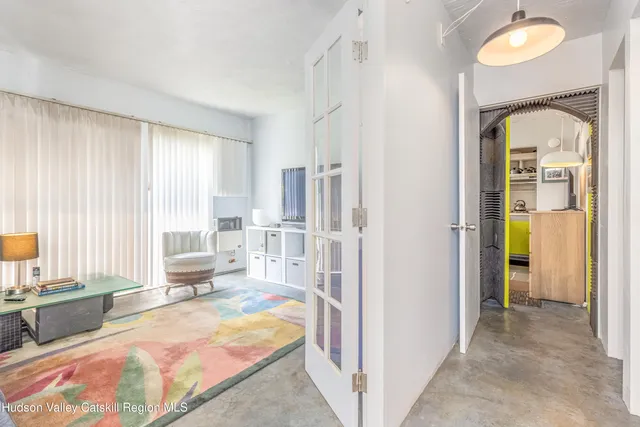 a bedroom with furniture and a large window