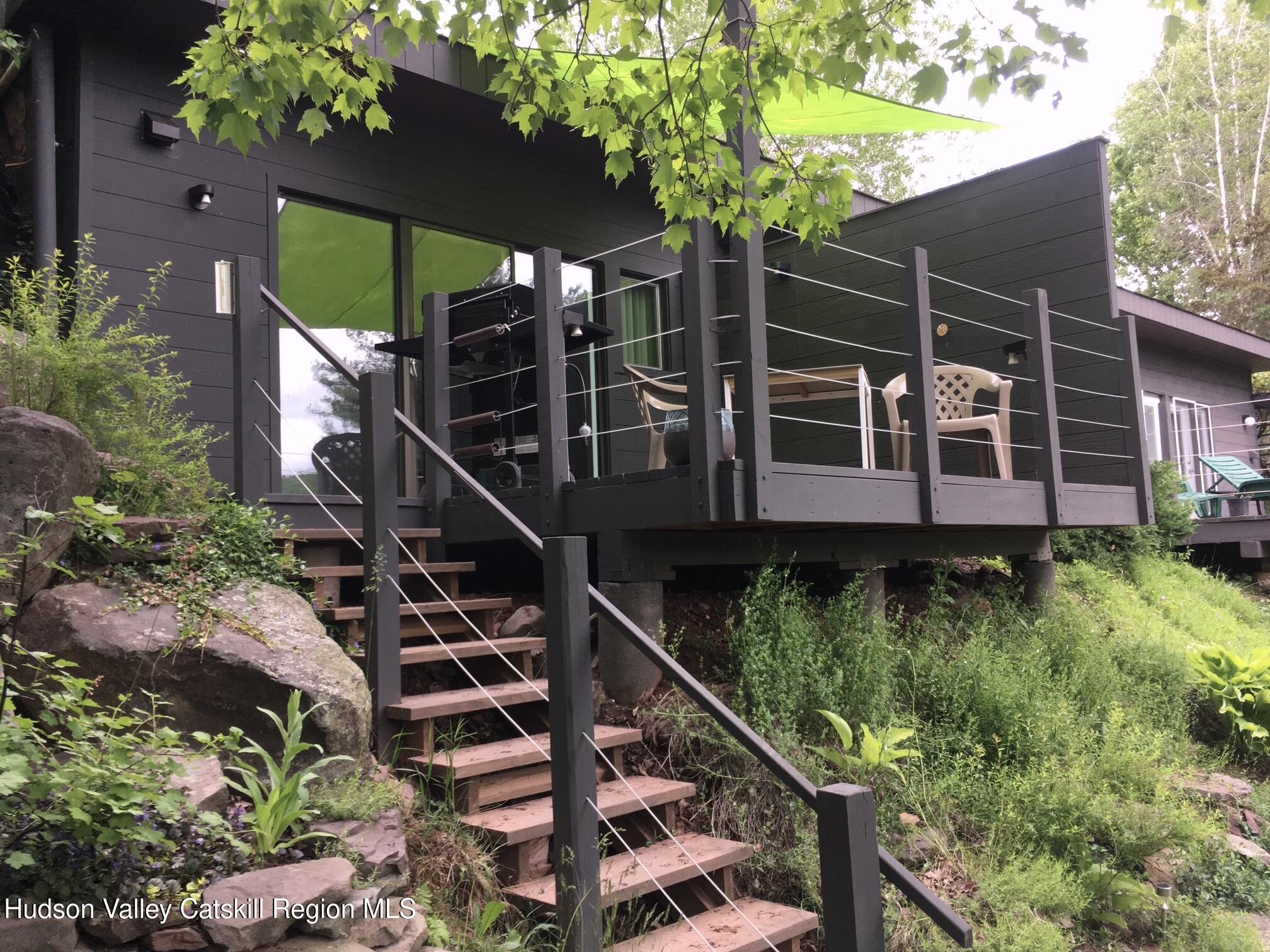 166 Todd Hill Road, Unit 166 West Kill, NY 12492 - Photo 25 of 42 a view of a house with a yard and a pool table and chairs