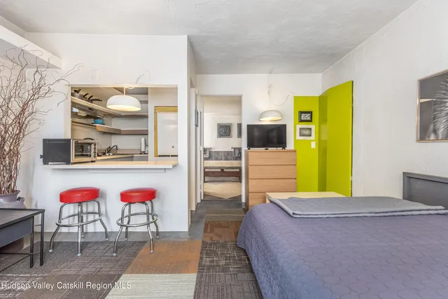 a bed room with a bed and dresser