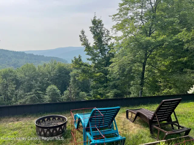 a view of house with a backyard and garden