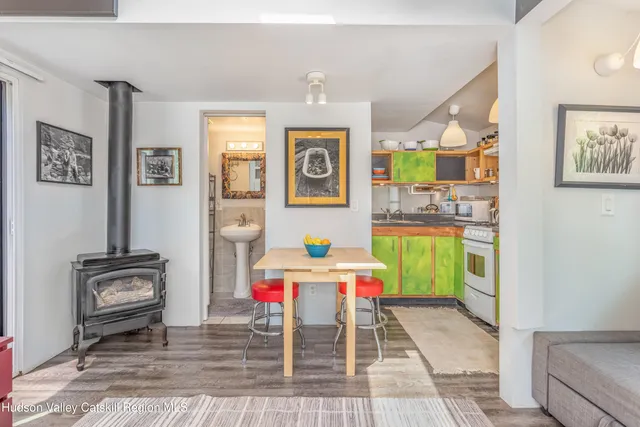 a kitchen with a stove a sink and a wooden table
