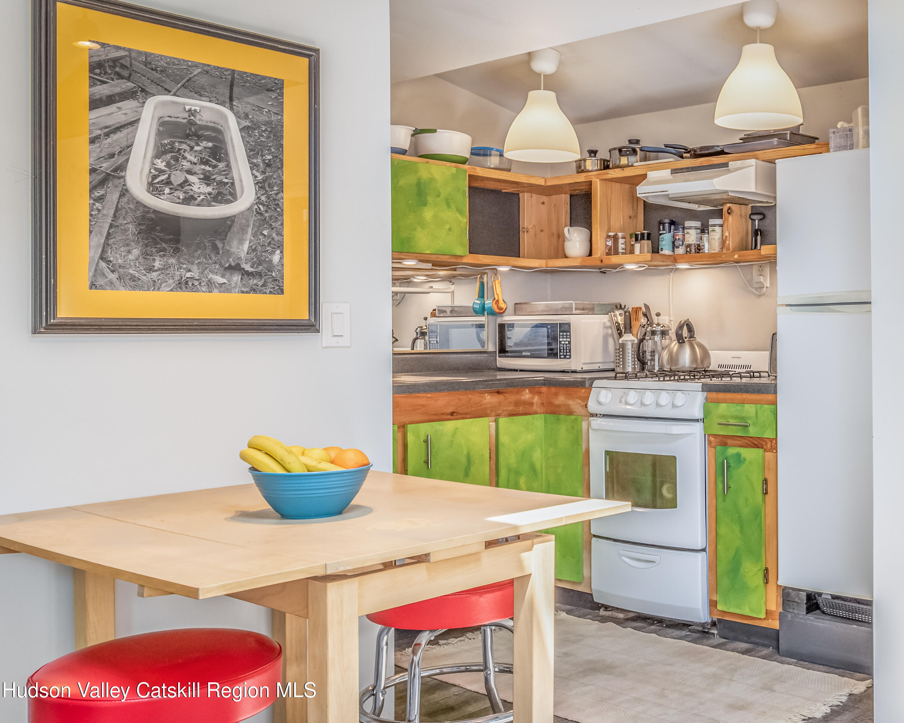 166 Todd Hill Road, Unit 166 West Kill, NY 12492 - Photo 36 of 42 a kitchen with a stove a sink and a wooden table