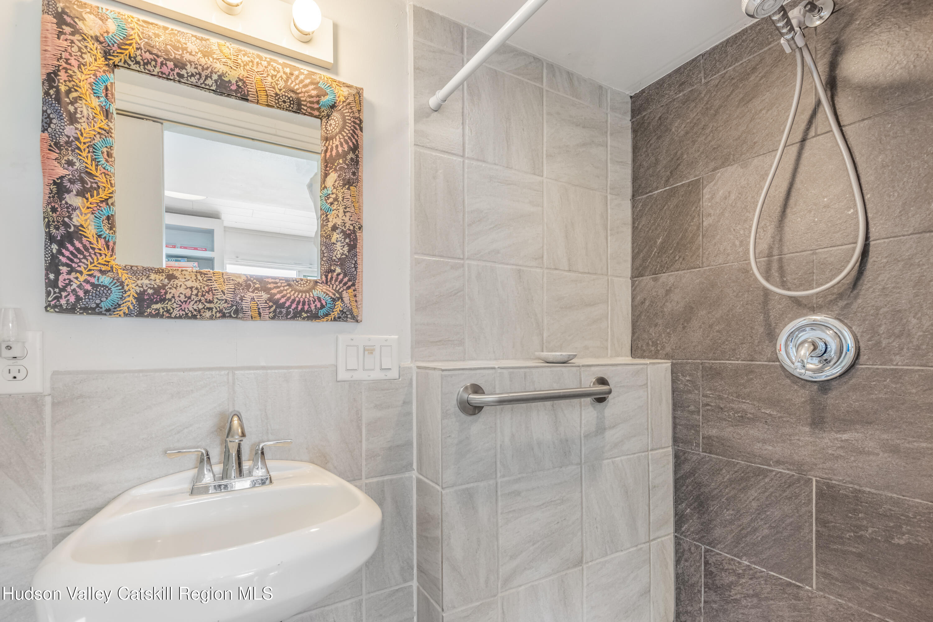 166 Todd Hill Road, Unit 166 West Kill, NY 12492 - Photo 37 of 42 a bathroom with a sink a mirror and a shower